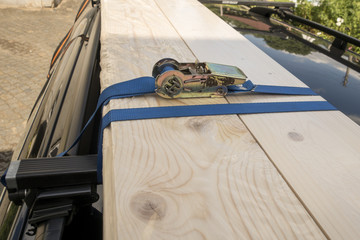 background of blue Ratchet Strap and wood boards