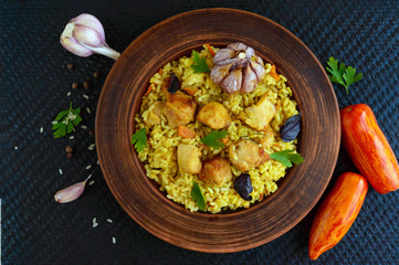 Boiled rice with roasted chicken, carrots, spices (traditional Asian dish - pilaf). The top view