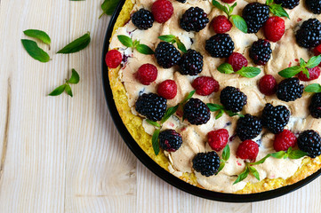Pie (Tart) with fresh blackberries and raspberries, air meringue, decorative mint. Close up. The top view