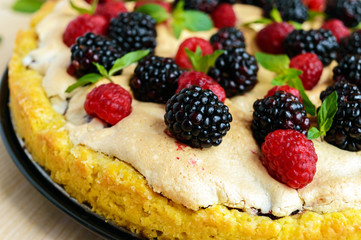 Pie (Tart) with fresh blackberries and raspberries, air meringue, decorative mint. Close up