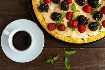 Pie (Tart) with fresh blackberries and raspberries, air meringue, decorative mint and cup of coffee