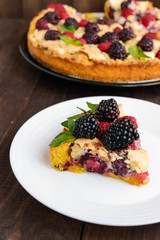 A piece of the pie (Tart) with fresh blackberries and raspberrie