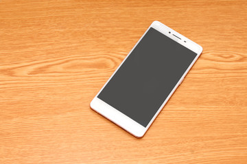 mobile phone on wooden desk