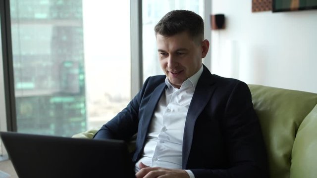 very emotional businessman enjoys a good deal of news to email