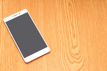 mobile phone on wooden desk