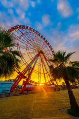 Ferris wheel on amazing sunset sky background