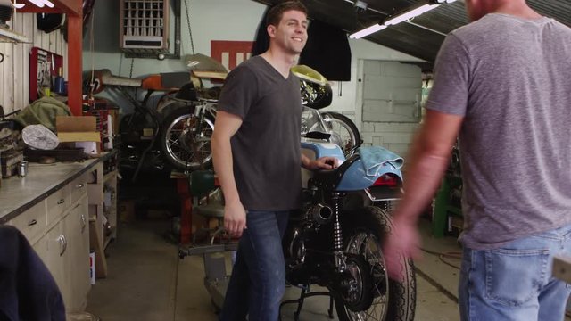 Two men working on motorcycle