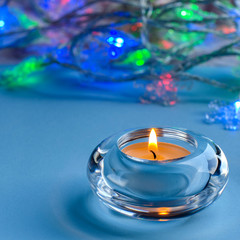 Obraz na płótnie Canvas Christmas and winter holidays. Candle on blue background.
