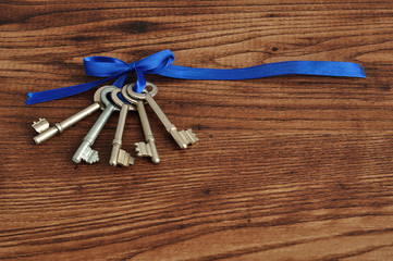 Keys tied together with a blue ribbon