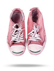 Old and dirty pair of sneakers on white