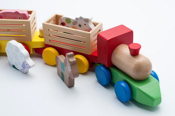 Obraz premium Wooden toy train with colorful blocks isolated over white