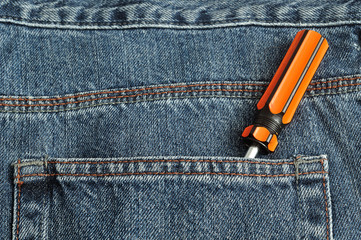 A screw driver in the back pocket of a denim 