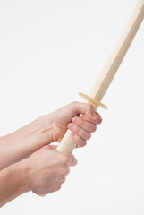 Wooden sword katana for training kendo in hands.
