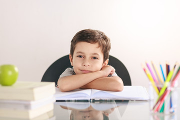 Candid portrait of a boy doing his homework and studying at home