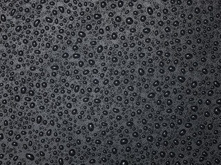 Abstract drops of water on black leather texture