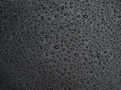 Abstract drops of water on black leather texture