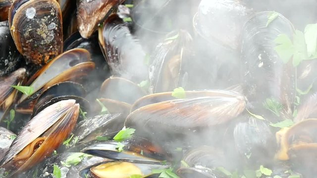 Mussels are boiling in a large cauldron, slow motion