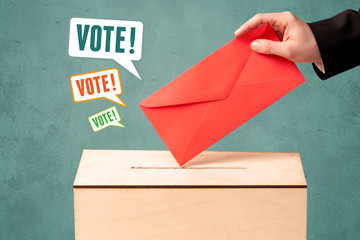 placing a voting slip into a ballot box