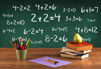 School blackboard with pile of books