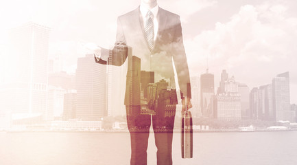 Businessman standing at cityscape background