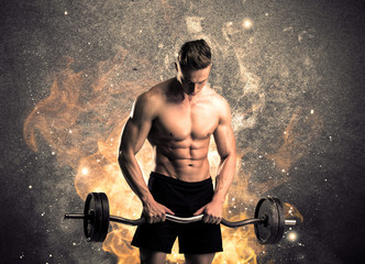 Healthy hot male showing muscles with fire