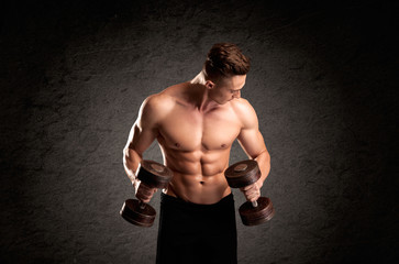 Fototapeta premium Sexy weight lifter guy showing muscles