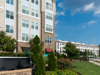 Modern apartment complex exterior with landscaping