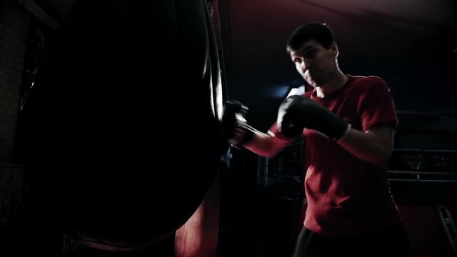 boxer hits a punching bag, slow motion