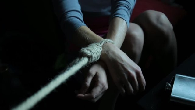 depression and emotional instability. social tensions. sad lonely woman with his hands tied. forcible retention of people, kidnapping
