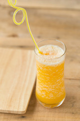 Glass of Orange Smoothie on wooden table