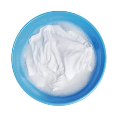 Soak whites clothes in the enameled bowl on white background