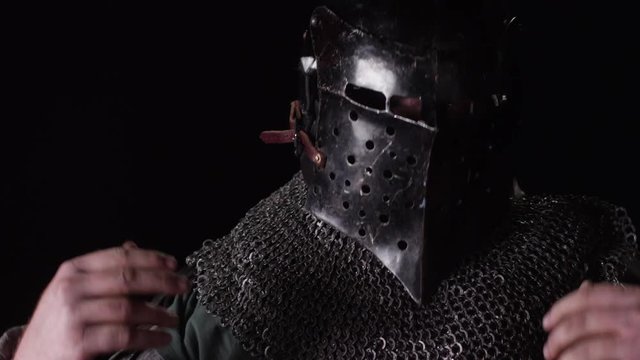 Knight in Armor Putting on Helmet
