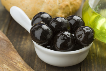black olives on rustic wooden