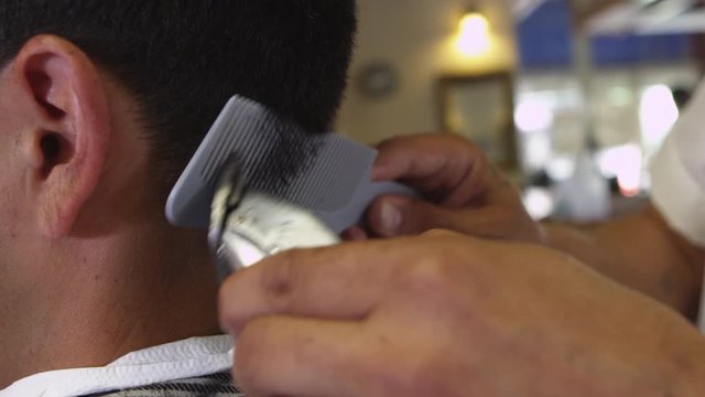 Closeup of man getting haircut at barber shop