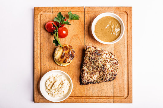 Beef Steak With Mustard Sauce On A White Background