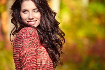 Fototapeta premium Beautiful elegant woman standing in a park in autumn , Fall conc