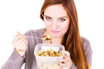 Woman eat oatmeal with dry fruits. Dieting