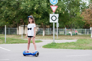 Girl riding on the hoverboard in the park