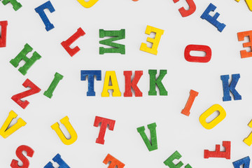 Series "Thank you": word thank you in Norwegian or Swedish  "takk" in wooden letters on white background

