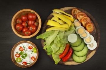 Fresh vegetables for snacks with dressing. Dip for vegetables. Healthy diet meal for dinner. Preparing vegetables in a home kitchen.
