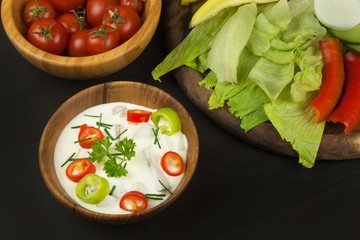 Fresh vegetables for snacks with dressing. Dip for vegetables. Healthy diet meal for dinner. Preparing vegetables in a home kitchen.
