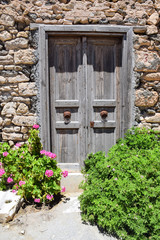 Stone wall with arched wooden door