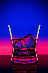 Drink in bar on color abstract background