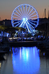 Night lights in the port of Antibes France, ferris wheel 