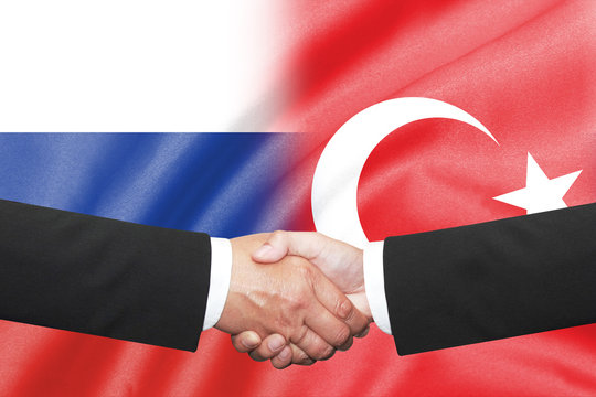 Businessman Shakehand Over Russia And Turkey Flag