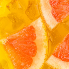 Obraz na płótnie Canvas Close-up of ice cubes in orange and grapefruit juice