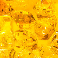 Close-up of ice cubes in orange juice