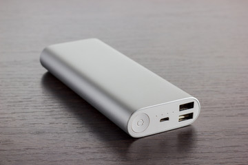 Silver aluminum power banks - dark wooden background