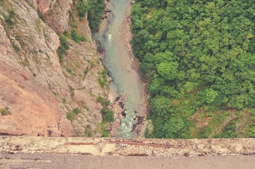 High angle view on the dramatic river canyon from the bridge; shot from directly above. Tara river gorge, Durmitor, Montenegro. Image filtered in faded, retro, Instagram style. - 119206228