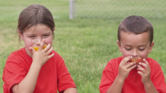 Children eating snacks after practice